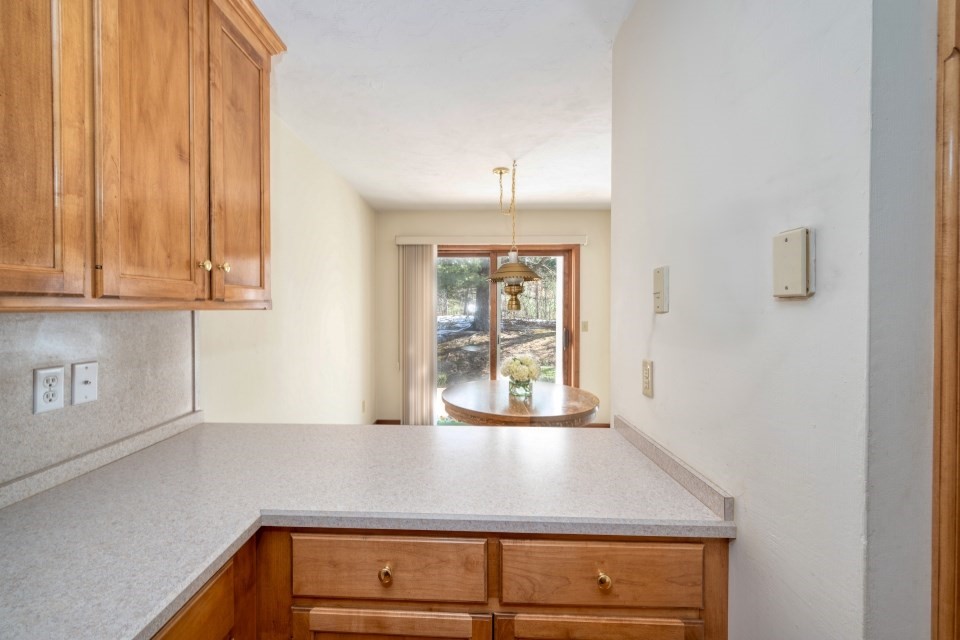 305 Centre Ln., Unit 305 Walpole, MA 02081 - Photo 11 of 23 a view of a kitchen with wooden floor and cabinets