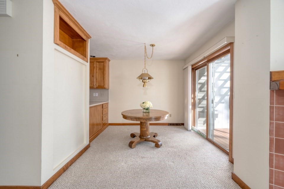 305 Centre Ln., Unit 305 Walpole, MA 02081 - Photo 5 of 23 a view of a room with a window and wooden floor