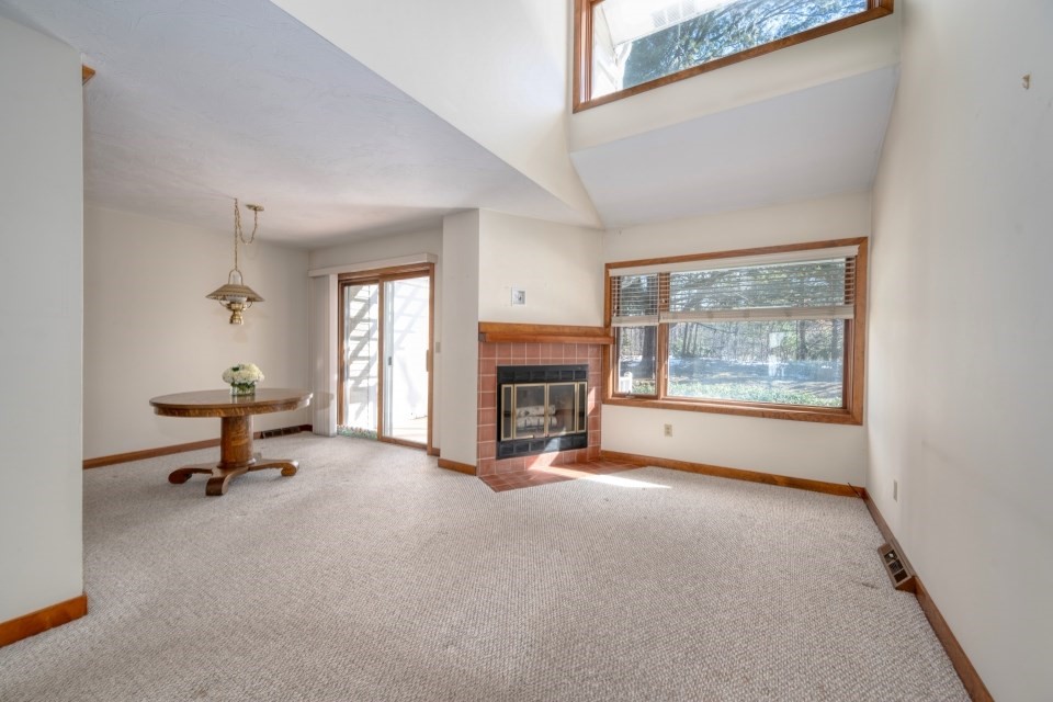 305 Centre Ln., Unit 305 Walpole, MA 02081 - Photo 6 of 23 a view of a livingroom with a fireplace and window