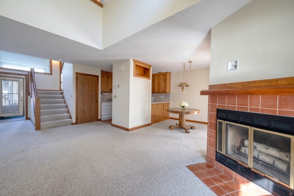 305 Centre Ln., Unit 305 Walpole, MA 02081 - Photo 7 of 23 a view of a livingroom with furniture and a fireplace