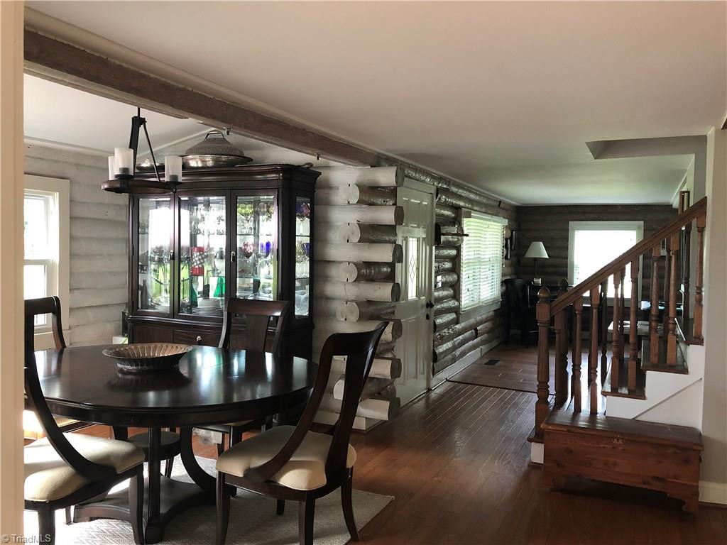 2021 Mountain View Road King, NC 27021 - Photo 26 of 29 Dining room view into living room (recreation room with fireplace). Door to back porch is on the left and steps upstairs is to the right.