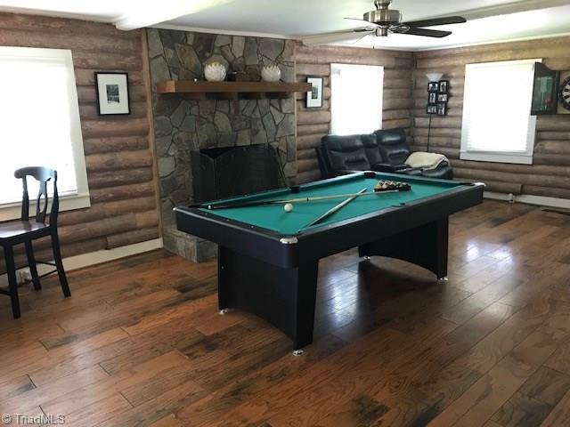Living room houses pool table and is presently used for recreation.  The fireplace burns wood now, but once was fueled by propane logs.