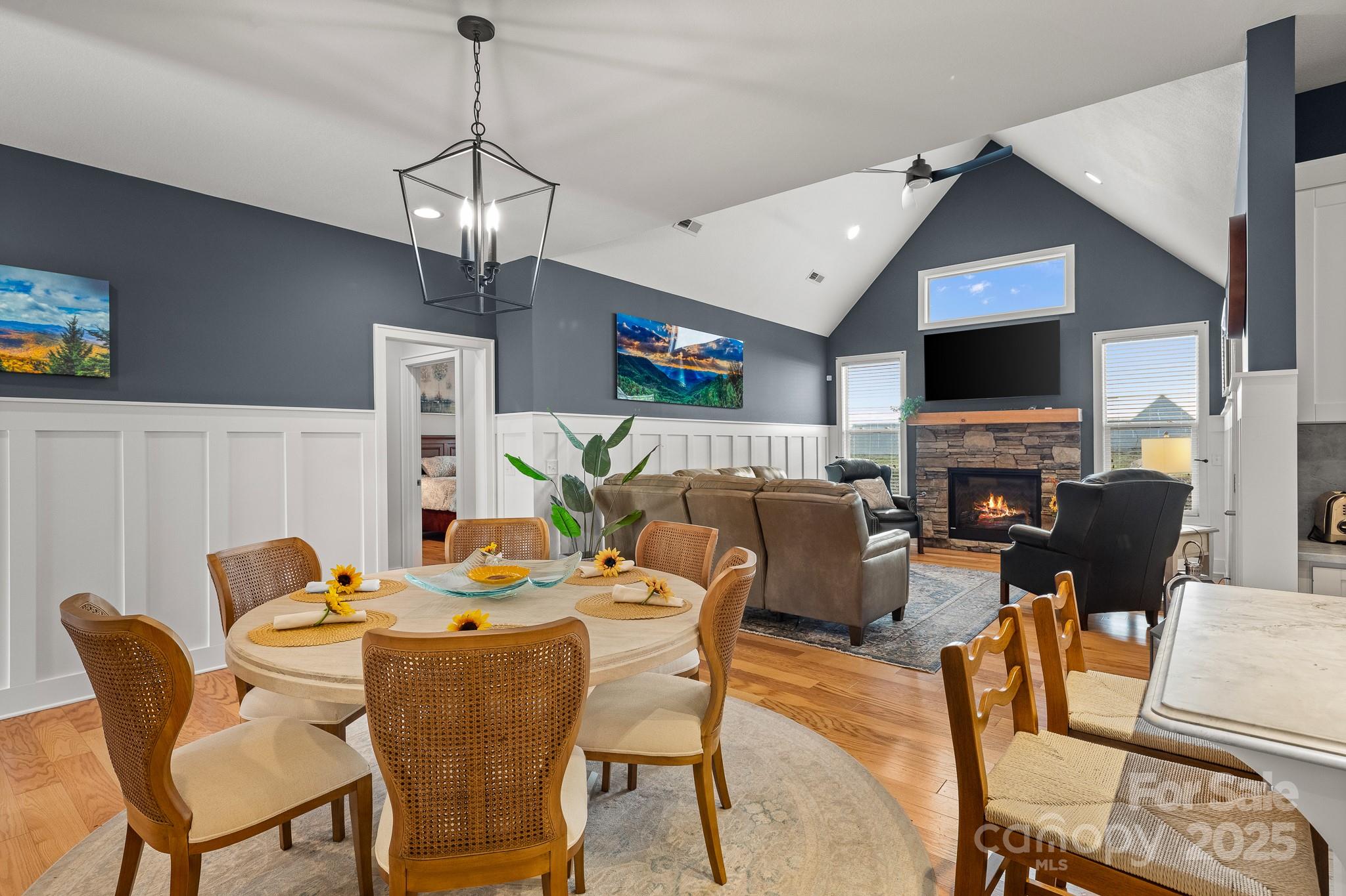 235 Windstone Drive Fletcher, NC 28732 - Photo 2 of 40 a dining room with furniture a fireplace and a chandelier