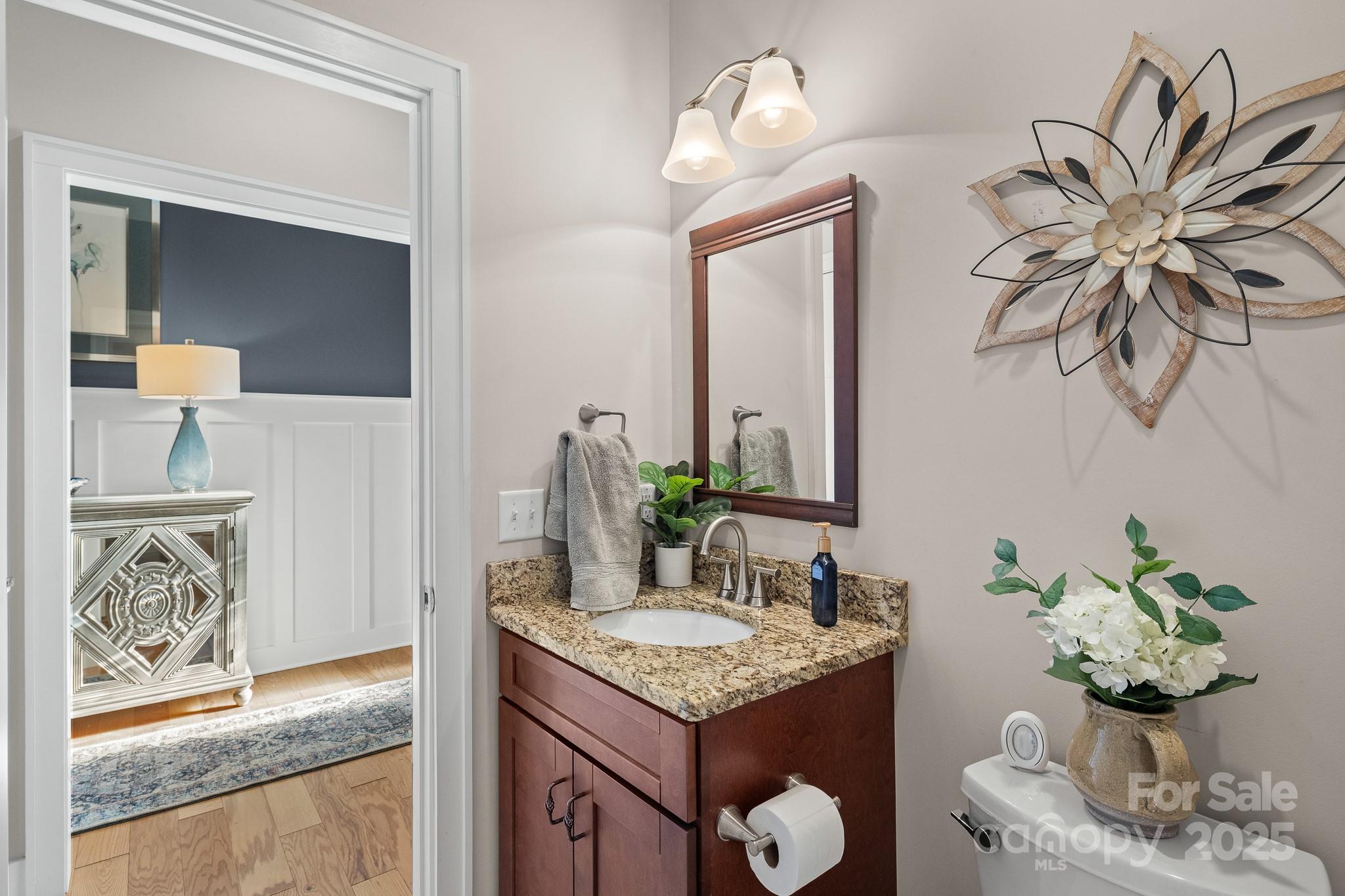 235 Windstone Drive Fletcher, NC 28732 - Photo 27 of 40 a bathroom with a granite countertop sink and a mirror