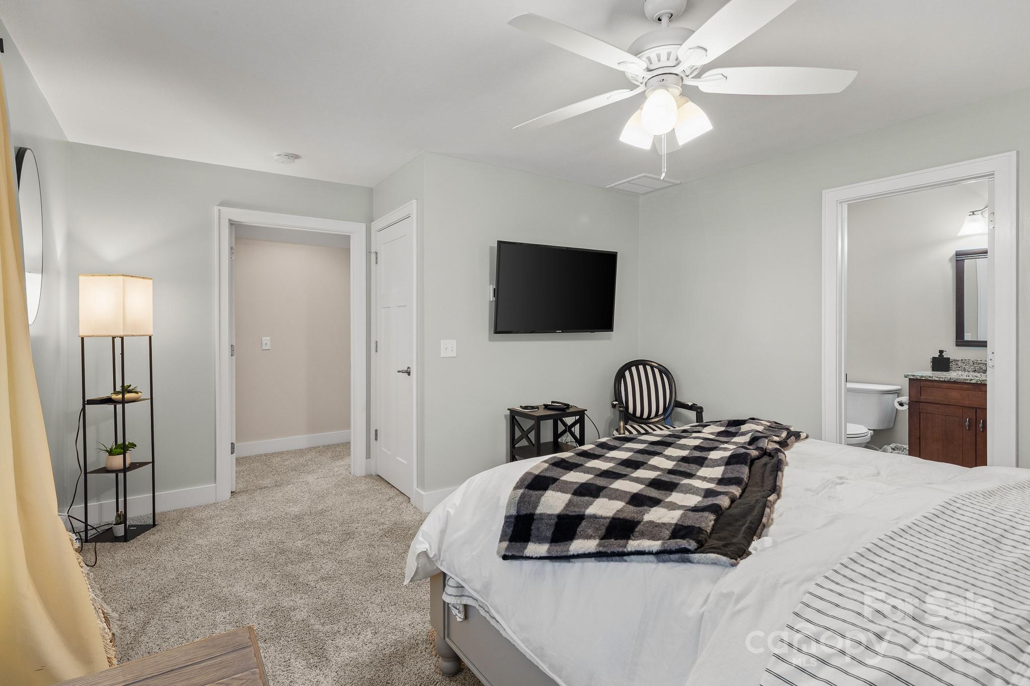 235 Windstone Drive Fletcher, NC 28732 - Photo 29 of 40 a bedroom with a bed and a flat tv screen on the dresser