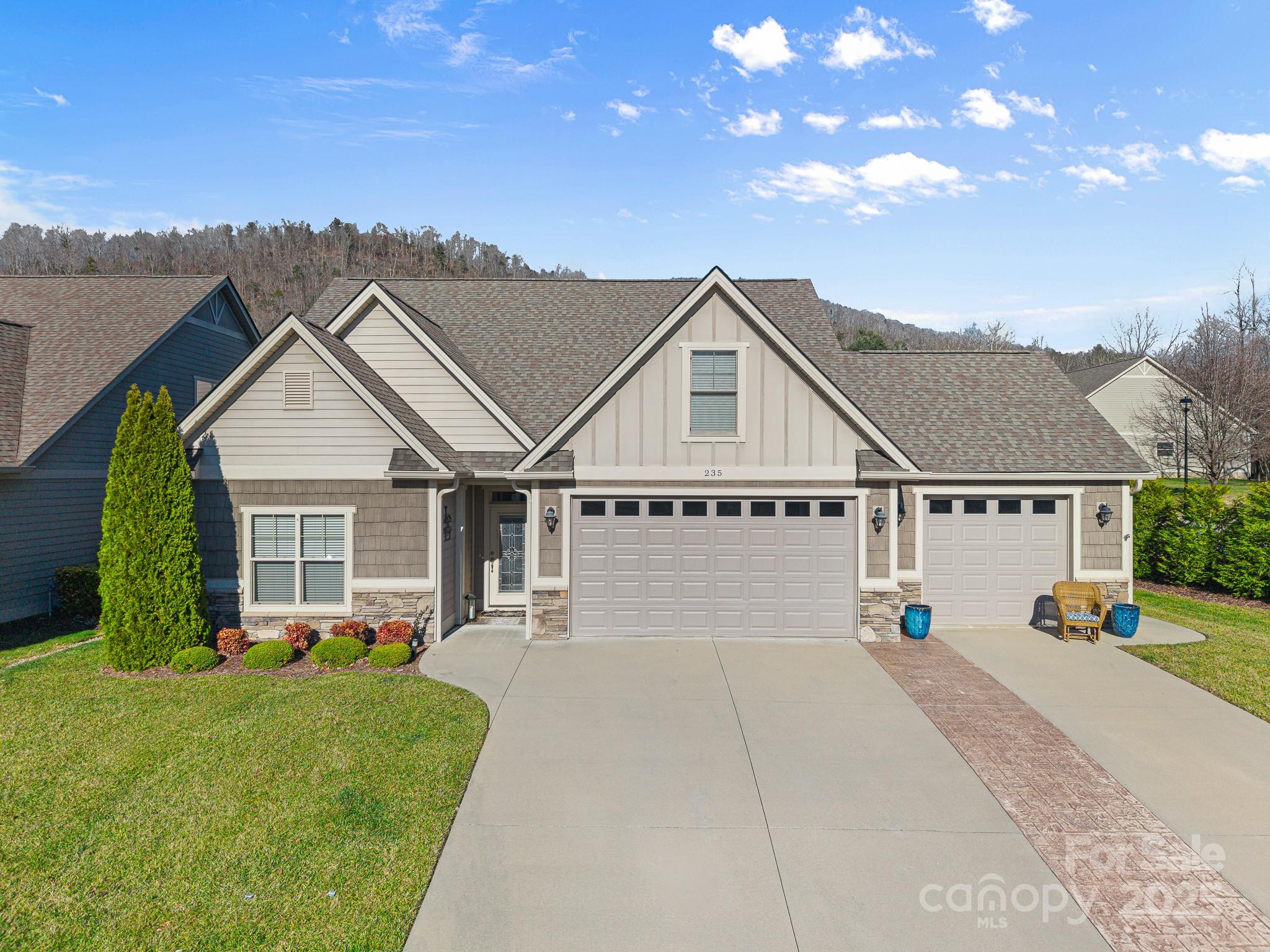 235 Windstone Drive Fletcher, NC 28732 - Photo 5 of 40 a view of a house with a chairs in a patio