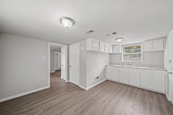 a kitchen with a refrigerator and a stove top oven