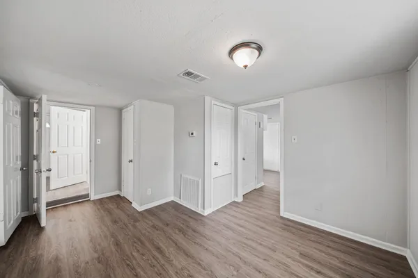 a view of an empty room and wooden floor