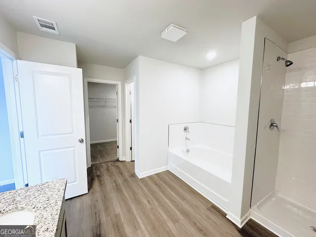 a bathroom with a bathtub and a shower