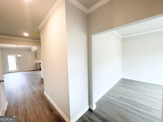a view of a hallway with wooden floor