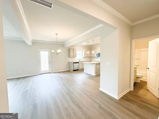 a view of a kitchen with wooden floor and a kitchen
