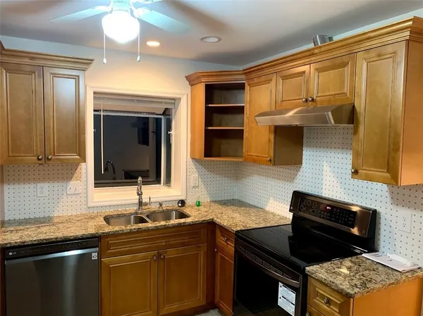 a kitchen with a sink stove and microwave
