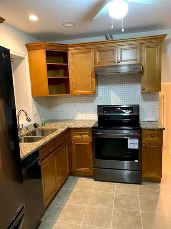 a kitchen with stainless steel appliances granite countertop a stove and a sink
