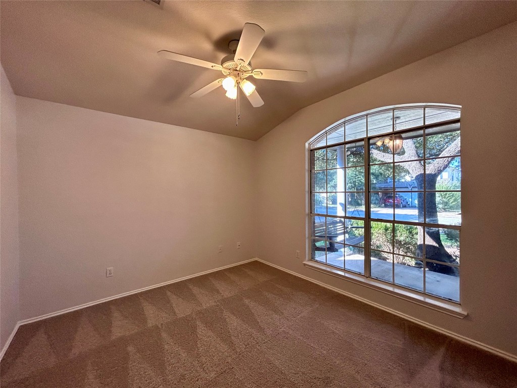 716 Leann Lane Cedar Park, TX 78613 - Photo 13 of 29 an empty room with chandelier fan and windows