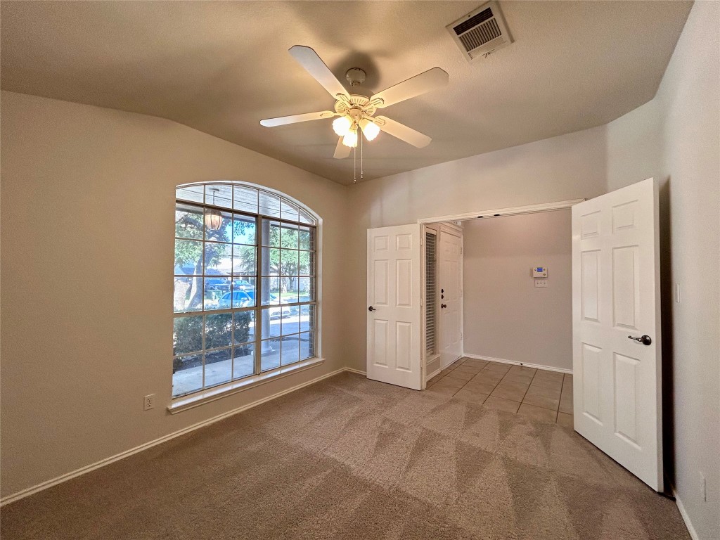 716 Leann Lane Cedar Park, TX 78613 - Photo 14 of 29 a view of an empty room with a ceiling fan and window