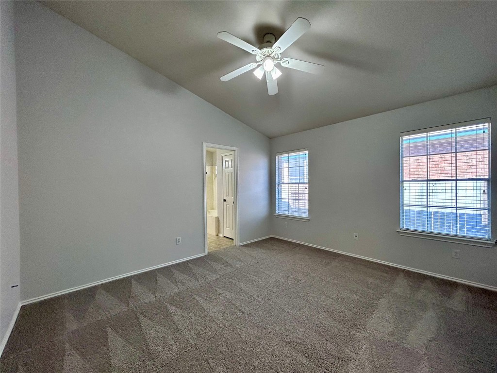 716 Leann Lane Cedar Park, TX 78613 - Photo 15 of 29 an empty room with chandelier fan and windows