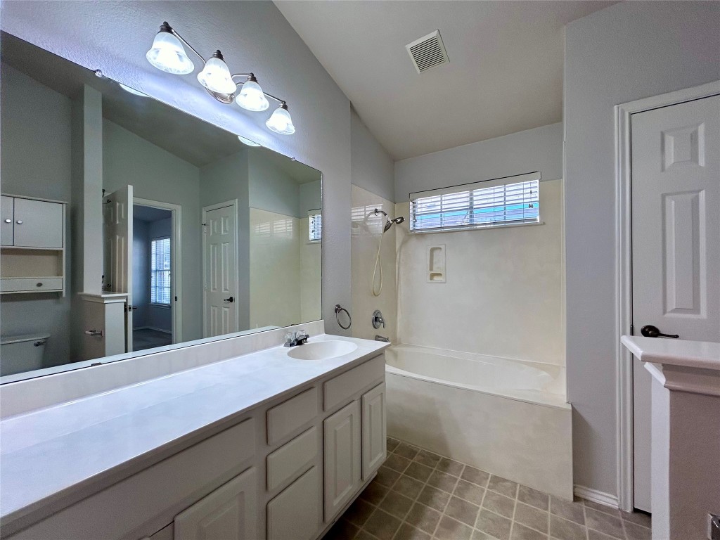 716 Leann Lane Cedar Park, TX 78613 - Photo 21 of 29 a bathroom with a double vanity sink a large mirror and shower