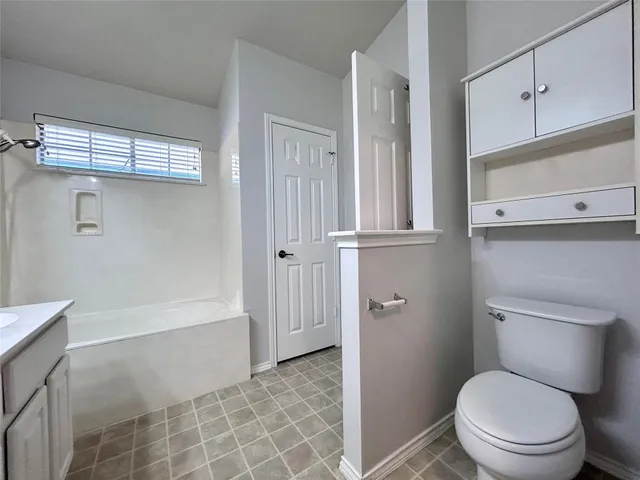 a bathroom with a toilet a sink and bathtub