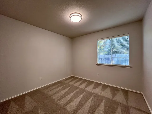 a view of a room with a air conditioner and a window