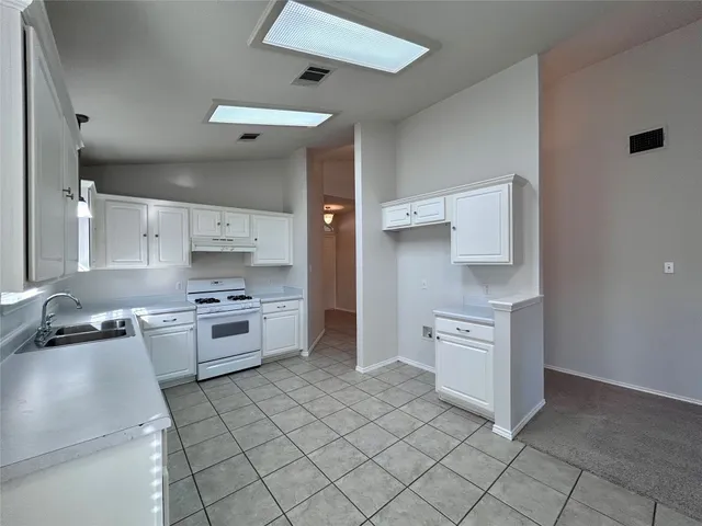 a kitchen with stainless steel appliances a stove sink and refrigerator