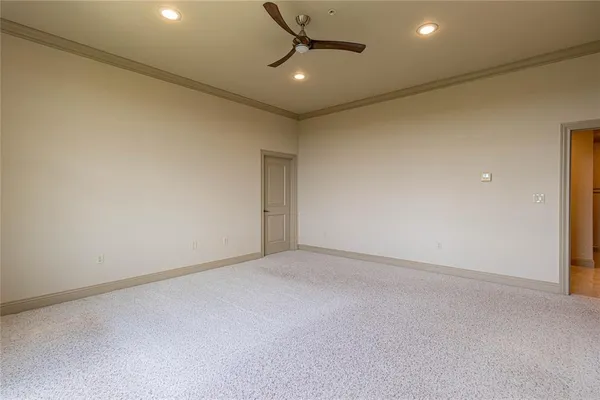 an empty room with a ceiling fan and window