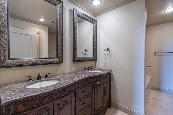 a bathroom with a granite countertop sink double and mirror