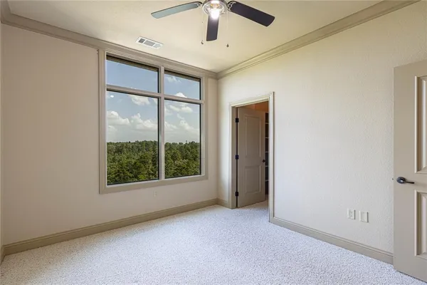 an empty room with windows and closet