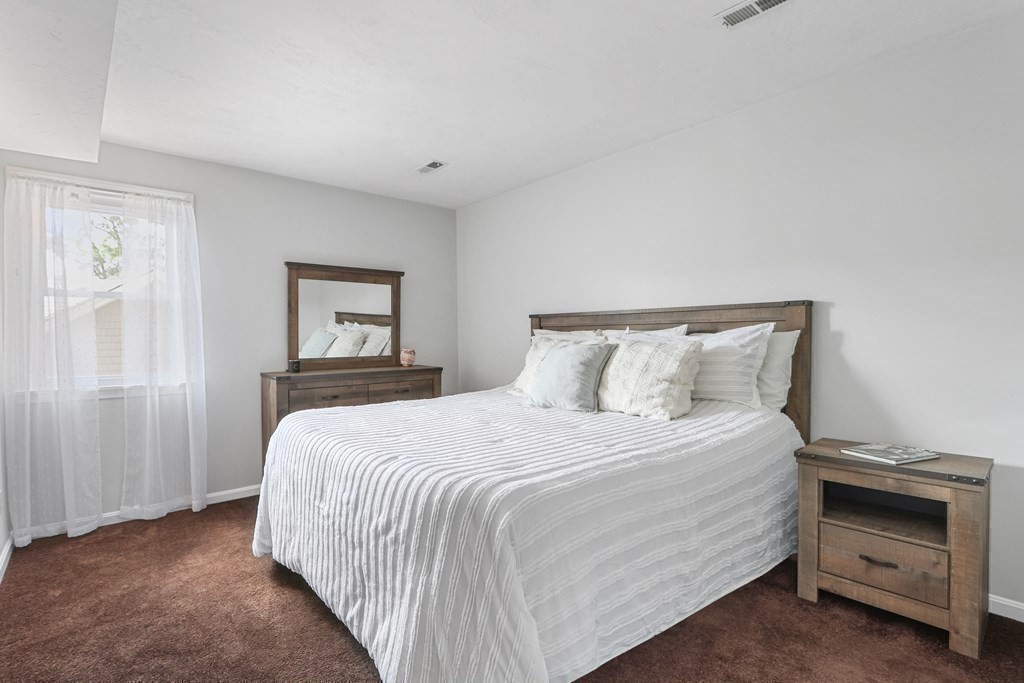 306 Tappan Street, Unit B Brookline, MA 02445 - Photo 14 of 35 a bedroom with a bed and a night stand