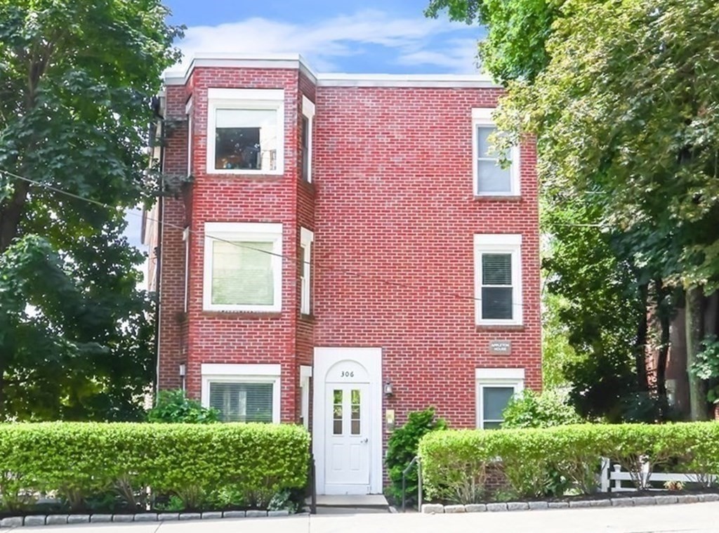 306 Tappan Street, Unit B Brookline, MA 02445 - Photo 2 of 35 front view of a brick house with a yard and large trees