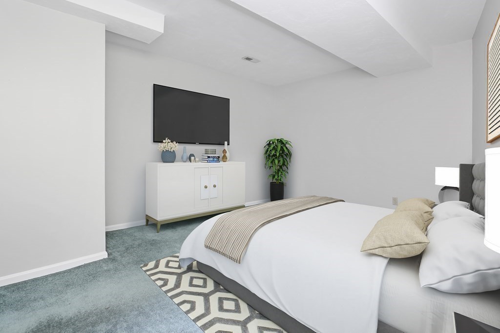 306 Tappan Street, Unit B Brookline, MA 02445 - Photo 21 of 35 a bedroom with a bed and a flat screen tv