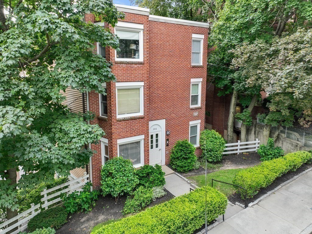 306 Tappan Street, Unit B Brookline, MA 02445 - Photo 33 of 35 a front view of a house with a yard and trees