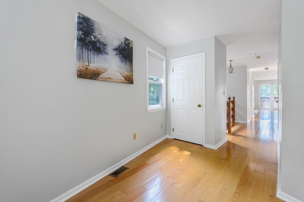 306 Tappan Street, Unit B Brookline, MA 02445 - Photo 7 of 35 a view of a room with wooden floor and wall painting