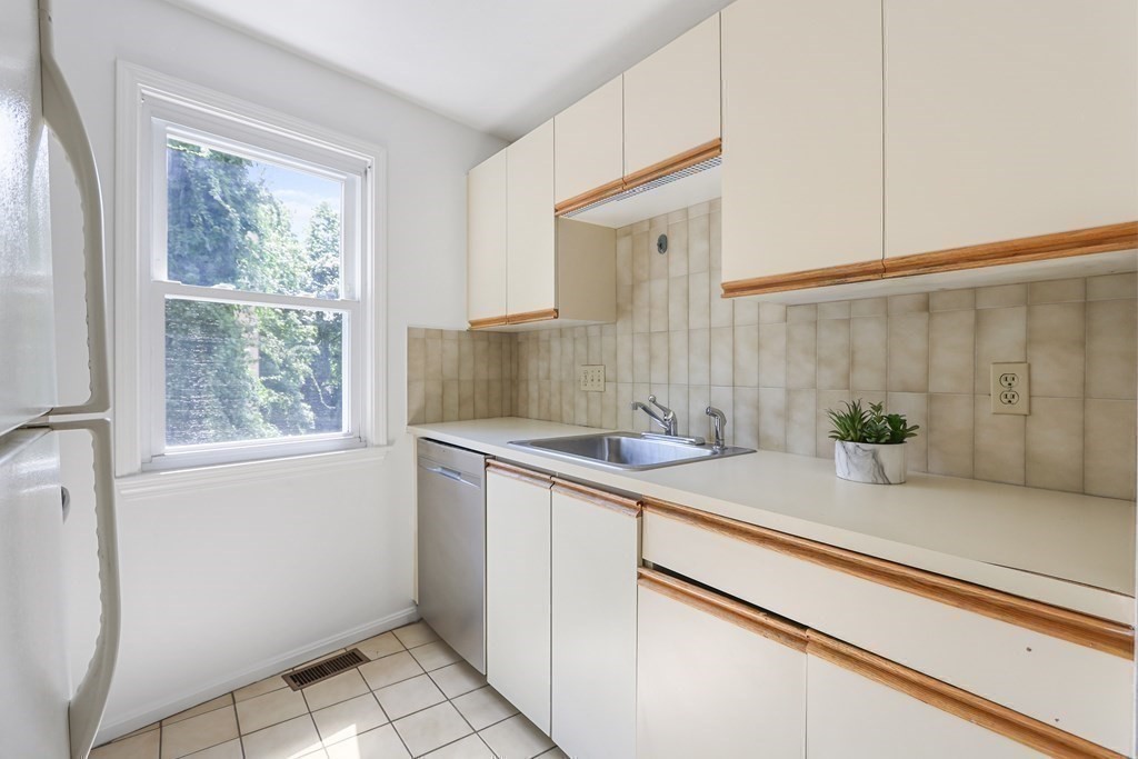306 Tappan Street, Unit B Brookline, MA 02445 - Photo 8 of 35 a kitchen with a sink and cabinets