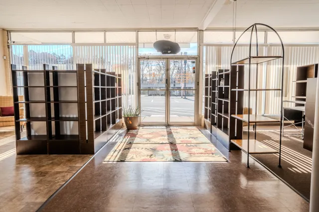 a view of a chairs and table in the back yard of the house