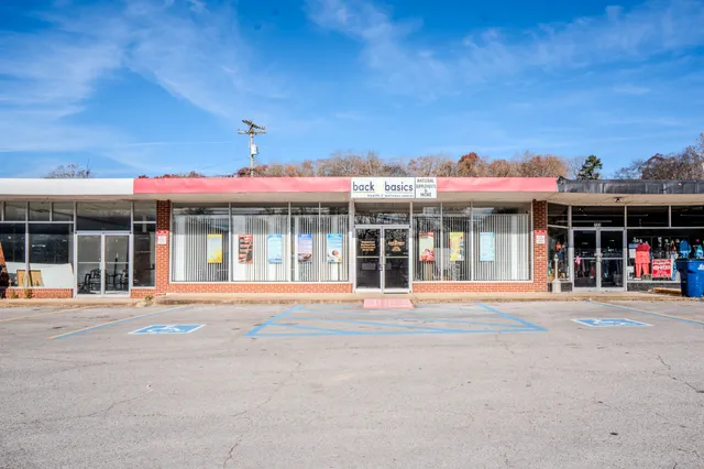 a front view of a building with a garden