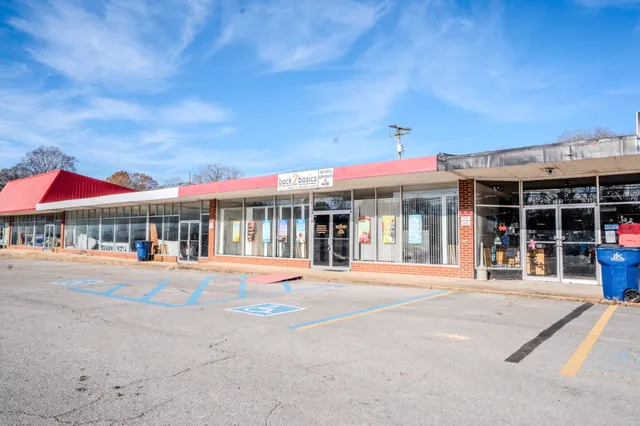 a front view of a building with a umbrellas