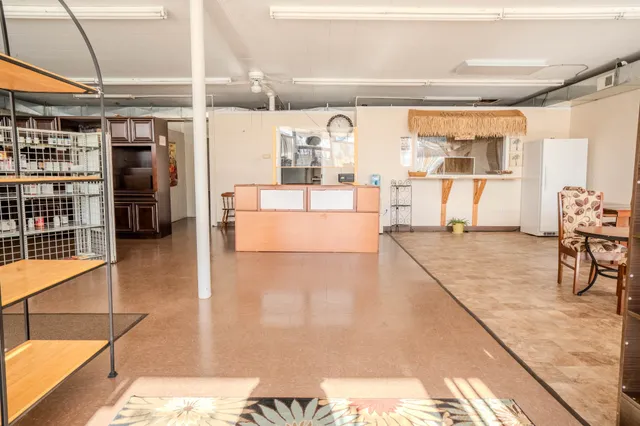 a living room with furniture and a floor to ceiling window