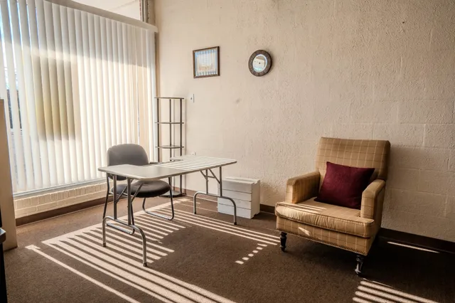 a view of livingroom with furniture and floor to ceiling window