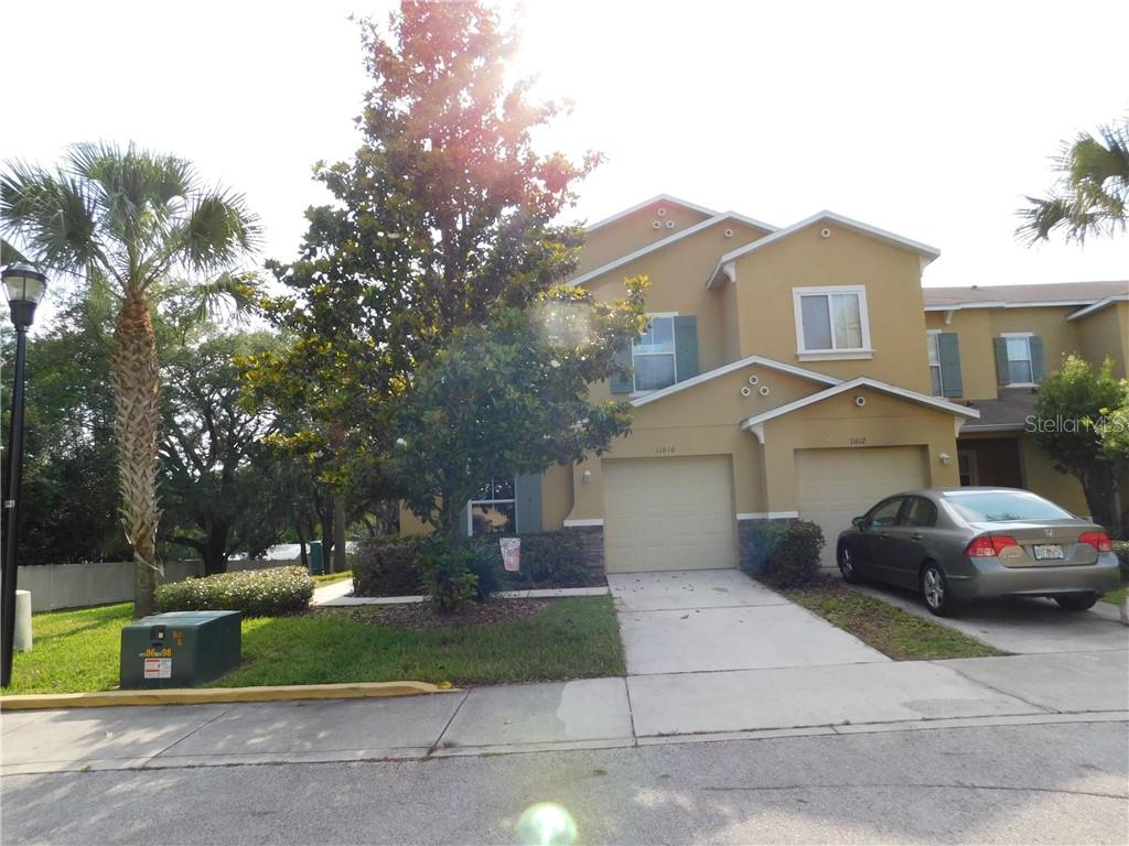 a front view of a house with a yard and a garage