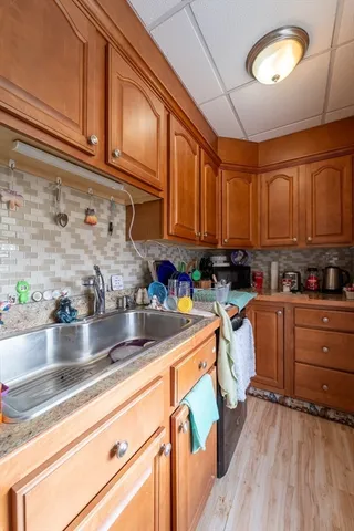 a kitchen with stainless steel appliances granite countertop a sink a stove and cabinets