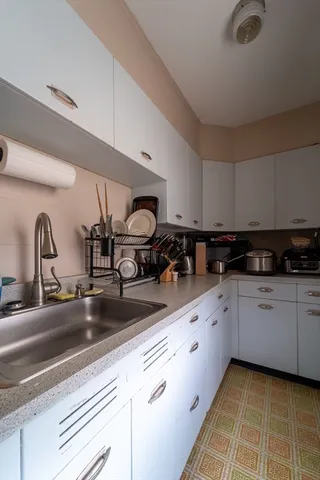 a kitchen with sink and stove
