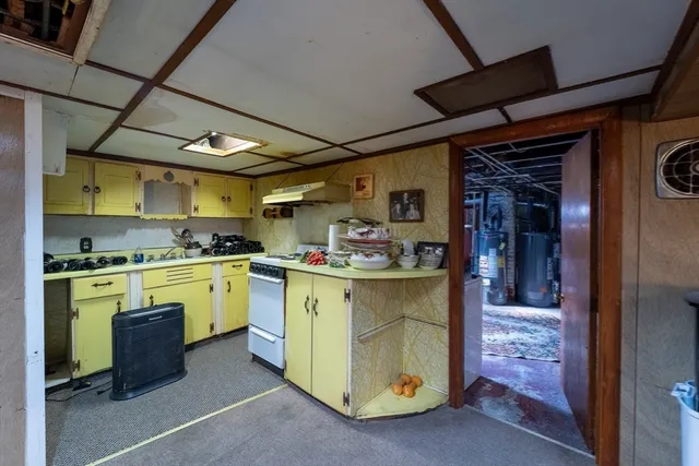 a kitchen with sink a stove and cabinets