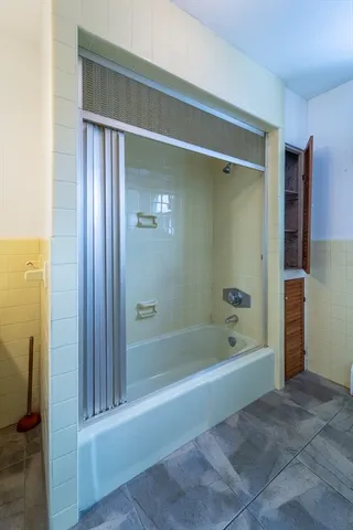 a bathroom with a bathtub and a shower