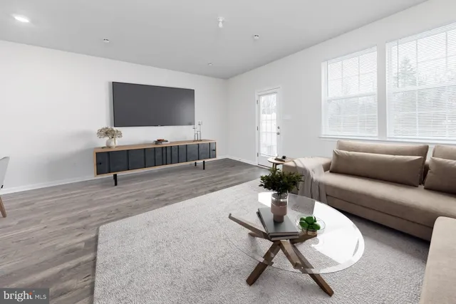 a view of a kitchen with wooden floor and electronic appliances