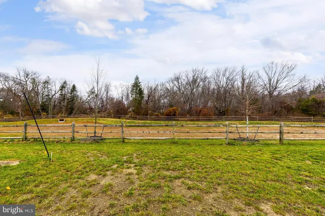 a view of yard with swimming pool and trees