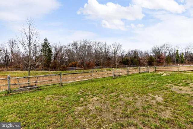 a view of kitchen with kitchen island and stainless steel appliances