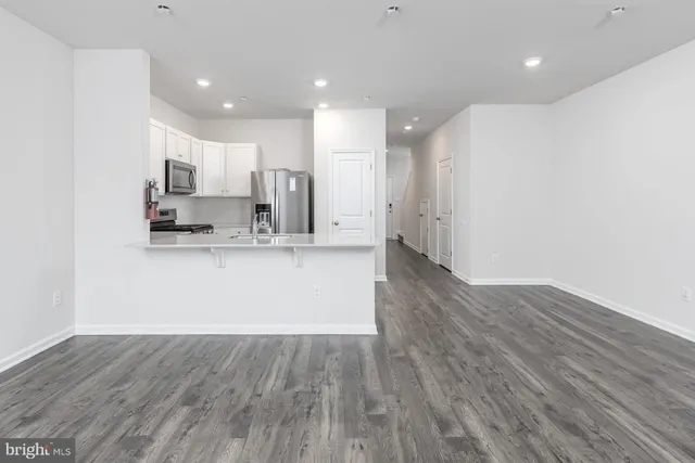 a living room with kitchen island furniture and a wooden floor