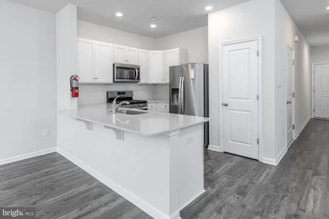 a kitchen with stainless steel appliances a stove sink and refrigerator