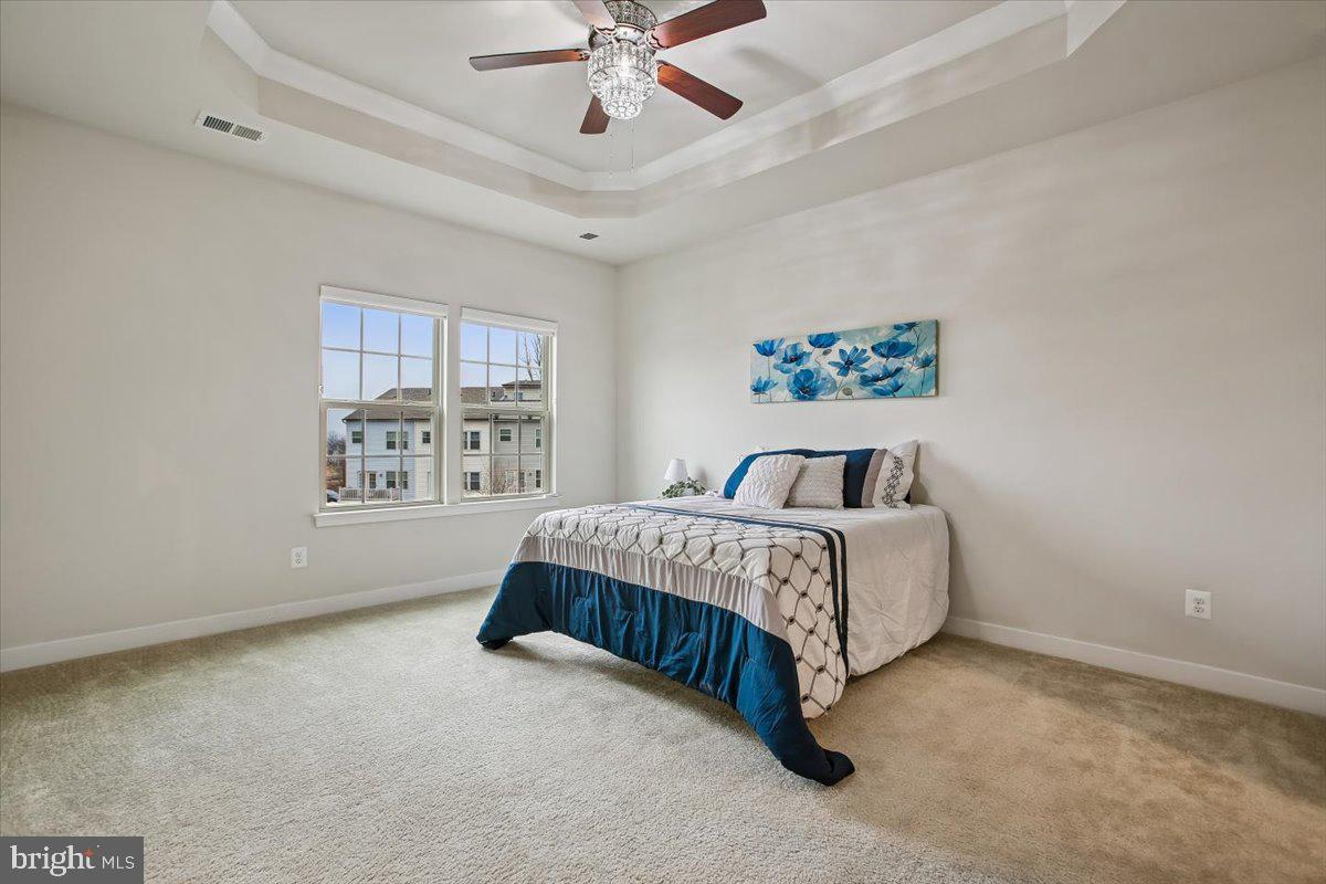 2105 Hemlock Bay Road Dumfries, VA 22026 - Photo 10 of 48 a spacious bedroom with a bed lamp and window