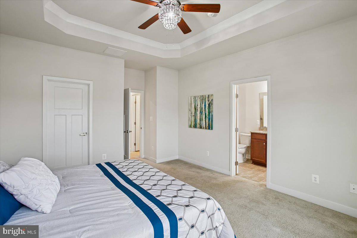 2105 Hemlock Bay Road Dumfries, VA 22026 - Photo 11 of 48 a bedroom with a bed and a chandelier